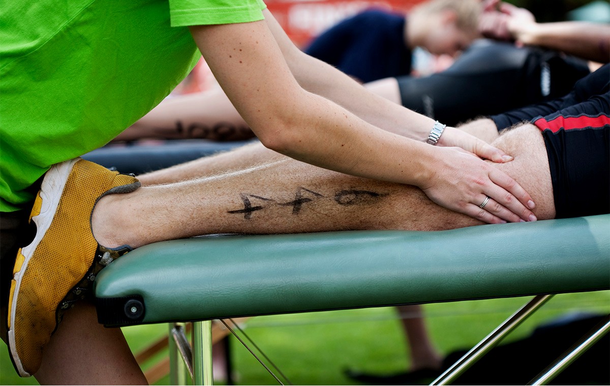 Lisa Harper, LMT providing sports massage at an outdoor event in Bend, Oregon